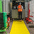 Yellow sitemat in use at construction site with a worker in hi-vis vest.